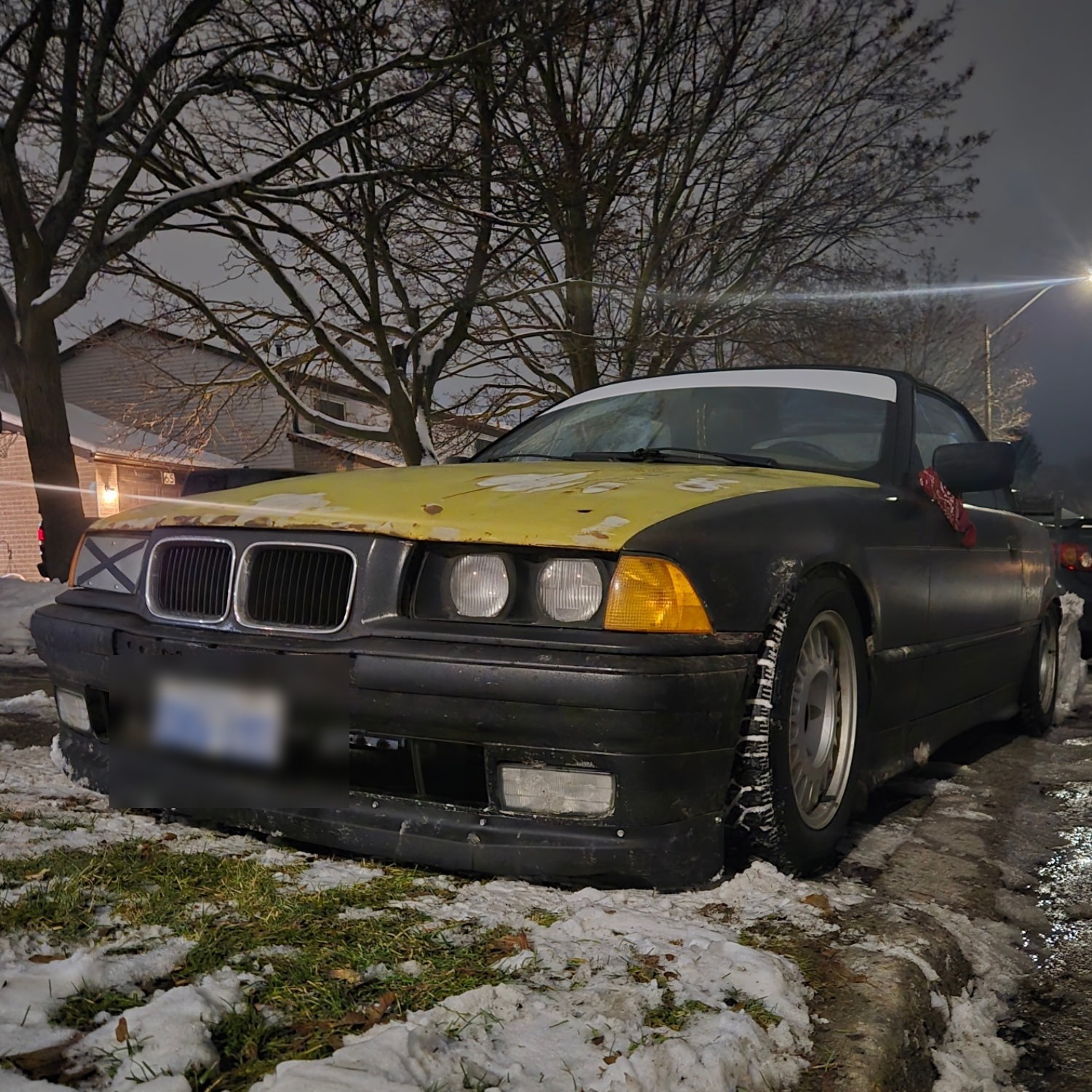 BMW E36 convertible in primer, mid-build at night