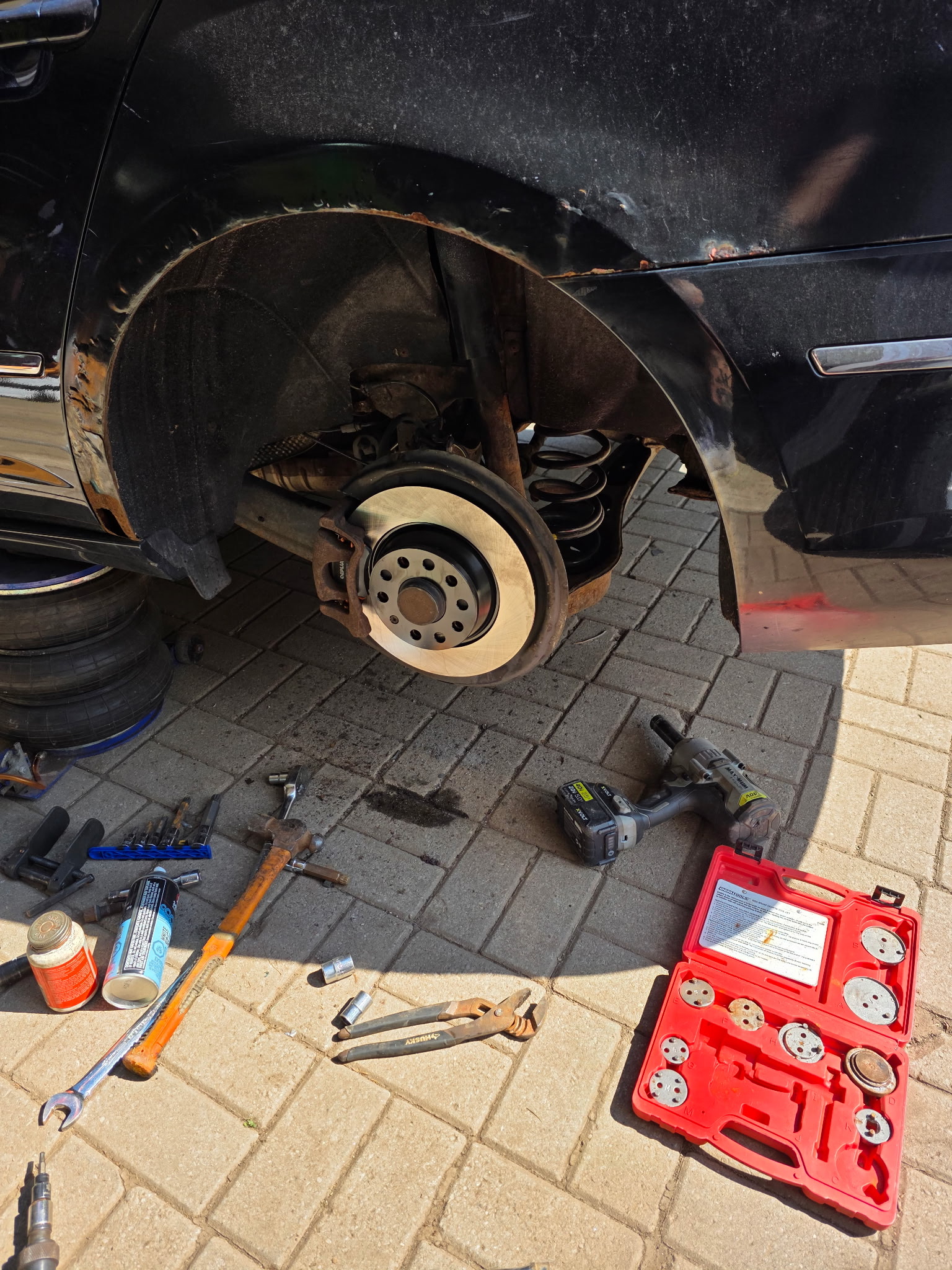 Brake job tools laid out in the driveway