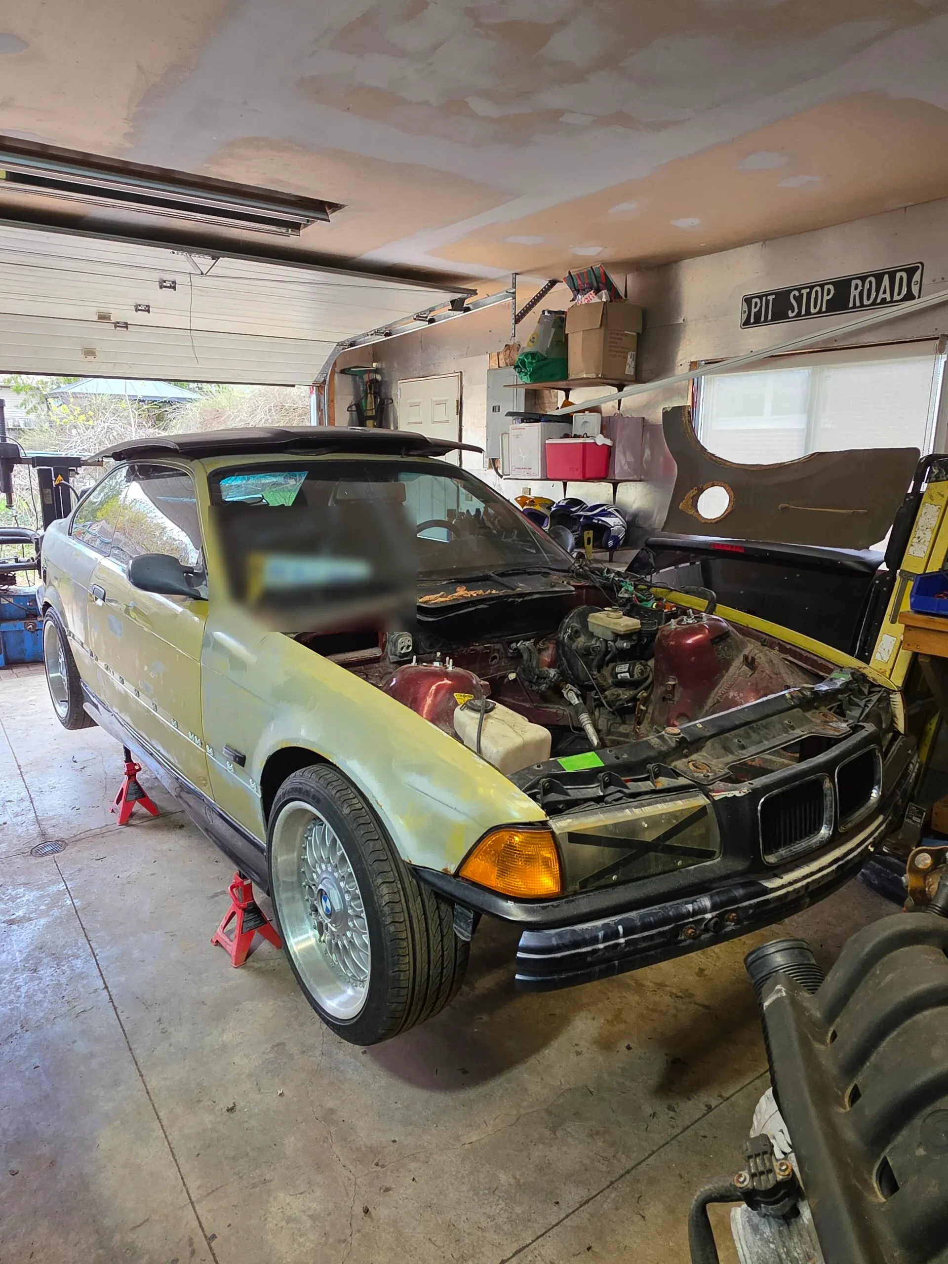 FTS garage interior, car up on stands